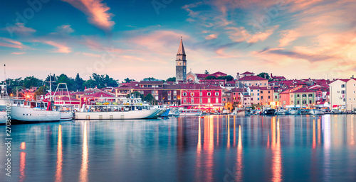 Splendid spring sunset of Rovinj town, Croatian fishing port on the west coast of the Istrian peninsula. Colorful evening seascape of Adriatic Sea. Traveling concept background.