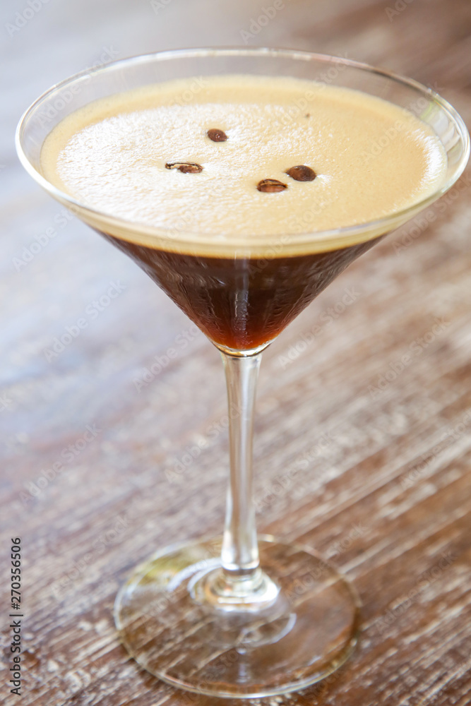 Espresso martini cocktail served on the wooden table