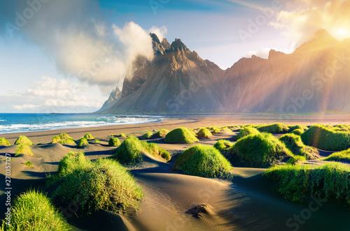 Impressive summer view of green dunes on the Stokksnes headland with Vestrahorn (Batman) mountain on background, southeastern Iceland, Europe. Beauty of nature concept background.