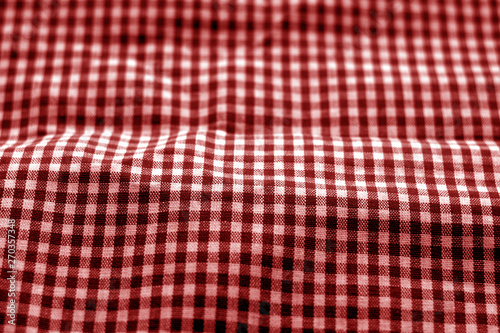 Checked fabric texture in blur effect in red tone.