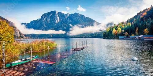 Foggy autumn scene of Altausseer See lake. Sunny morning panorama of Altaussee village, district of Liezen in Styria, Austria. Beauty of countryside concept background.