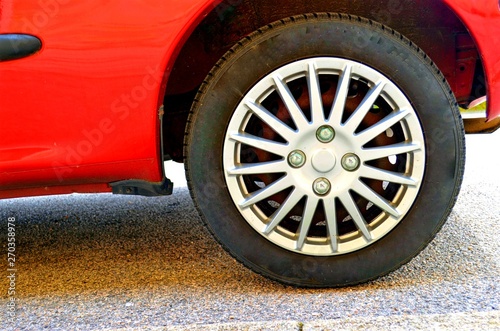 rear wheel of a red retro car closeup © Anastassiya