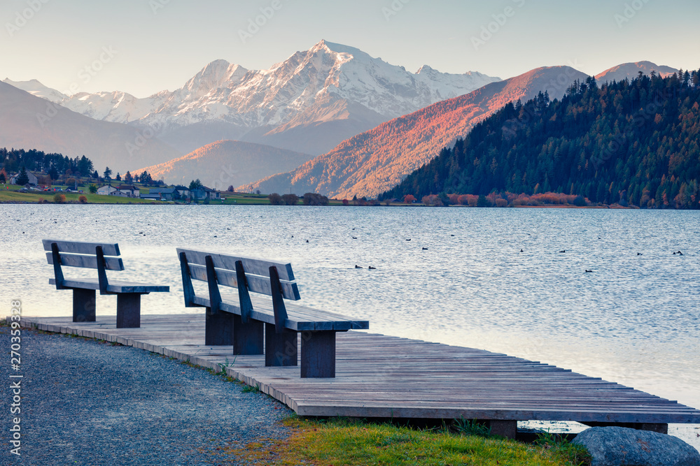 Obraz premium Beautiful autumn scene of Haidersee (Lago della Muta) lake with Ortler peak on background. Splendid morning view of Italian Alps, Italy, Europe. Beauty of countryside concept background.