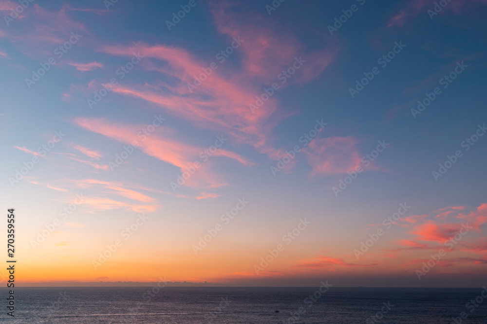 Colorful sunrise sky over the ocean horizon.