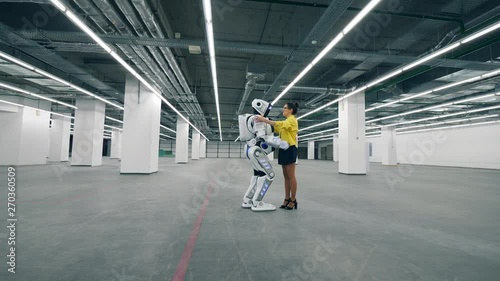 Wallpaper Mural Person and cyborg meet in a room, hugging each other. Torontodigital.ca