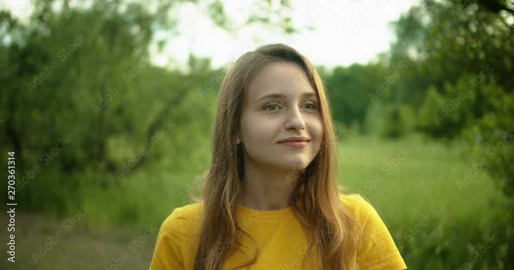 Beautiful girl smiling and looking at the camera in the forest Beautiful girl smiling and looking at the camera in the forest