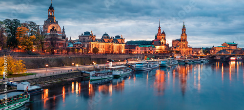Incredible evennig panorama of Cathedral of the Holy Trinity or Hofkirche, Bruehl's Terrace or The Balcony of Europe. Dramatic autumn sunset on Elbe river in Dresden, Saxony, Germany, Europe.