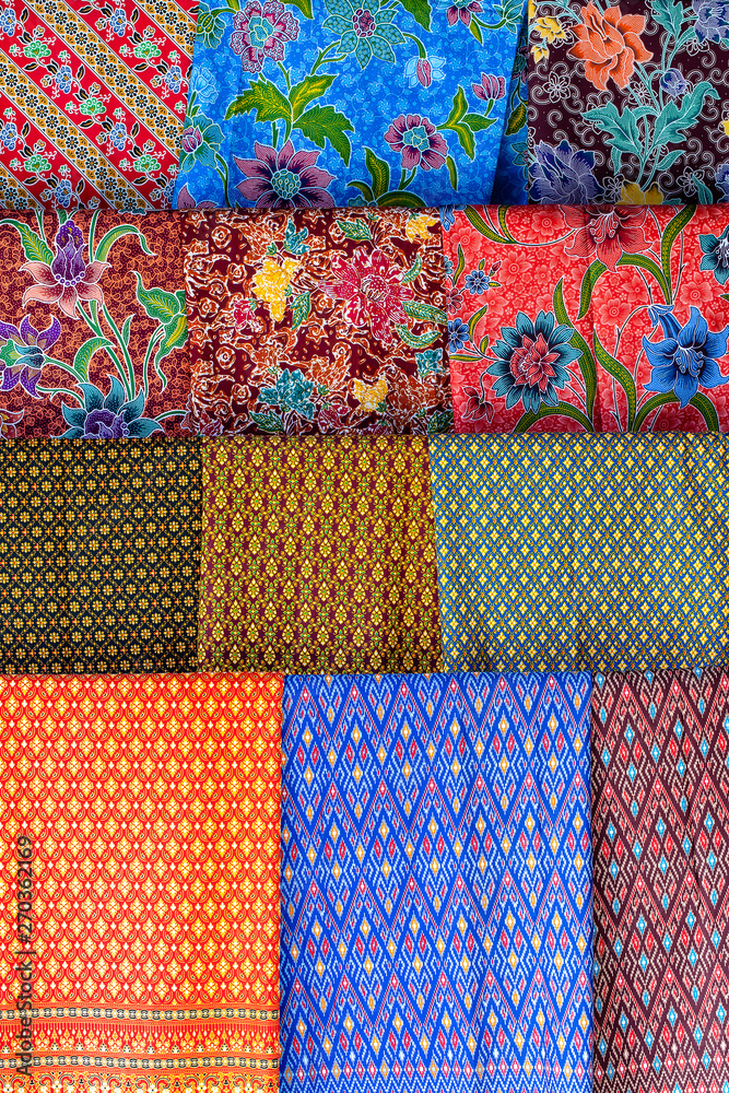 Colorful traditional sarongs for sale on street market in Thailand. Souvenirs for tourists at street market