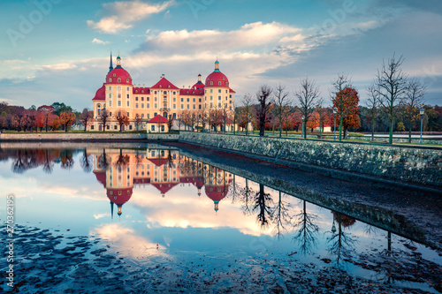 Great morning view of Moritzburg Baroque palace surrounded by a lake. Beautiful autumn scene of Saxony, Dresden location, Germany, Europe. Traveling concept background.