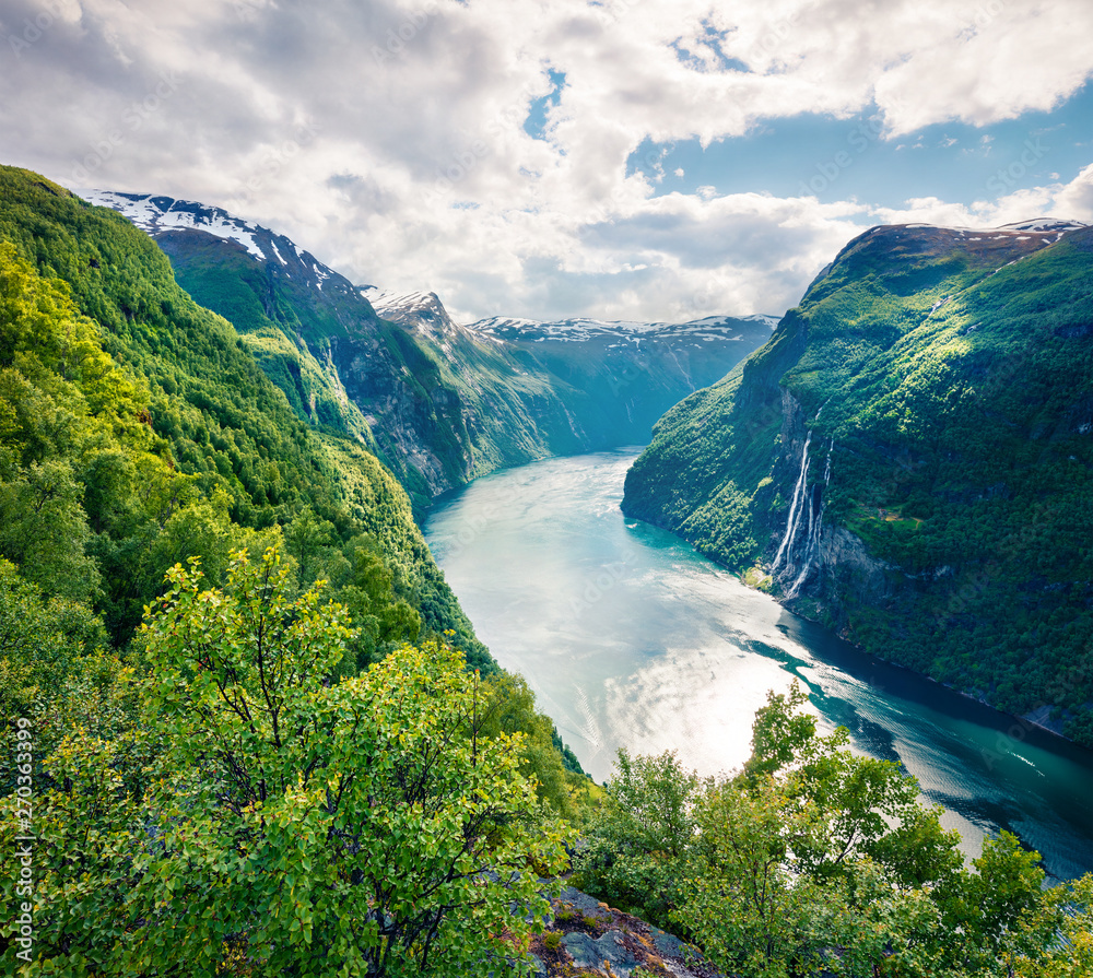 Great summer scene of Sunnylvsfjorden fjord, Geiranger village location, western Norway. Aerial view of famous Seven Sisters waterfalls. Beauty of nature concept background. Instagram filter toned.