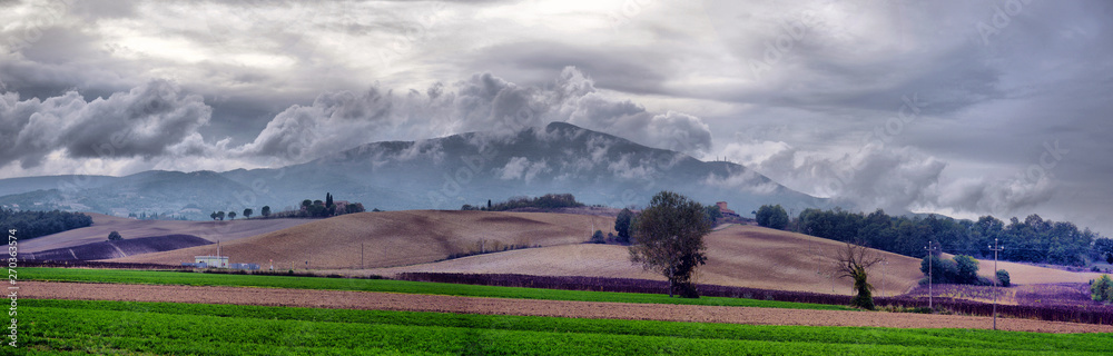 Fototapeta premium typical Tuscany countryside landscape; sunset over rolling hills