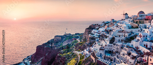 Impressive evening panorama of Santorini island. Picturesque spring sunset on the famous Greek resort Oia, Greece, Europe. Traveling concept background. Artistic style post processed photo. © Andrew Mayovskyy