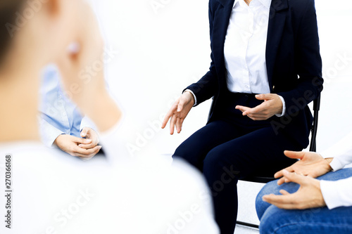 Group of people sitting in a circle during therapy. Meeting of business team participating in training