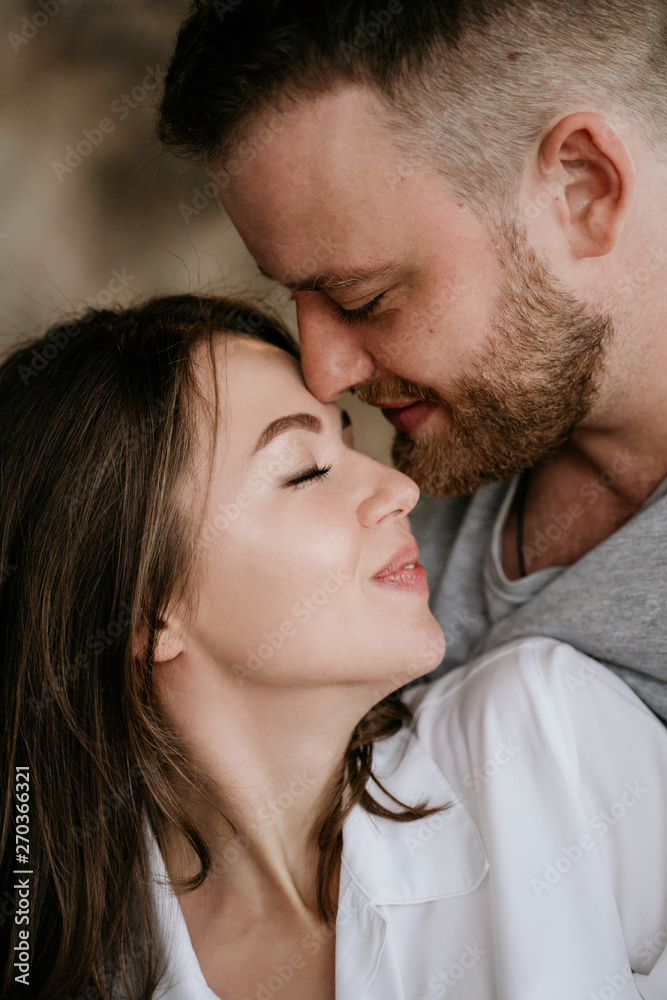 Couple in love in the bedroom. Slender brunette. Stylish interior. Couple in love in the bedroom. Slender brunette. Stylish interior.