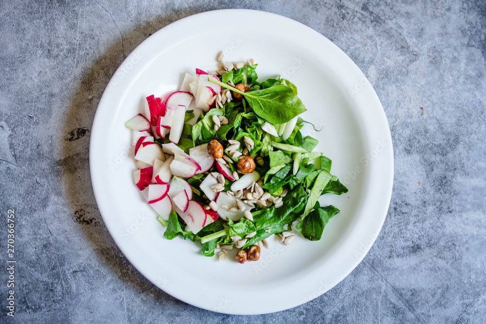 Fresh salad of cucumbers, radishes and herbs. Top view. Spring food concept. Fresh salad of cucumbers, radishes and herbs. Top view. Spring food concept.