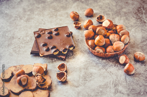 Hazelnut chocolate bar. Nuts and chocolate background. Ingredients for cooking homemade chocolate sweets. Confectionery and sweets concept. Toning.