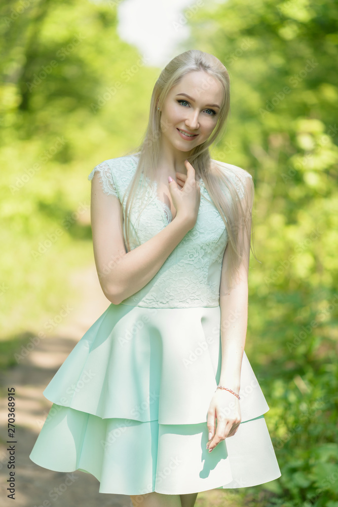 Summertime portrait of young woman in dress. Summertime portrait of young woman in dress.