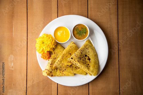 Holi festival, Traditional Maharashtrian food on the occasion of Holi. Puranpoli made of Jaggery. And cold drink made of curd. photo