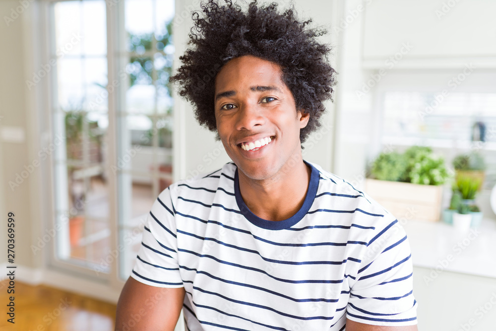 Fototapeta premium African American man wearing stripes t-shirt with a happy and cool smile on face. Lucky person.