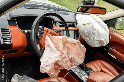 inside of damaged white car after accident on road
