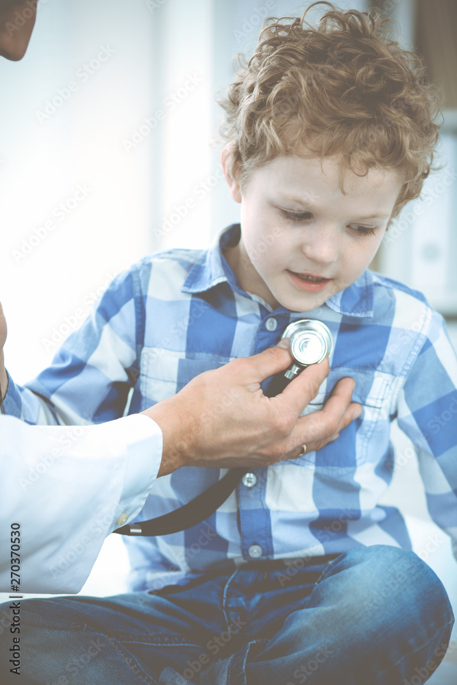 Doctor and patient child. Physician examining little boy. Regular medical visit in clinic. Medicine and health care concept Doctor and patient child. Physician examining little boy. Regular medical visit in clinic. Medicine and health care concept