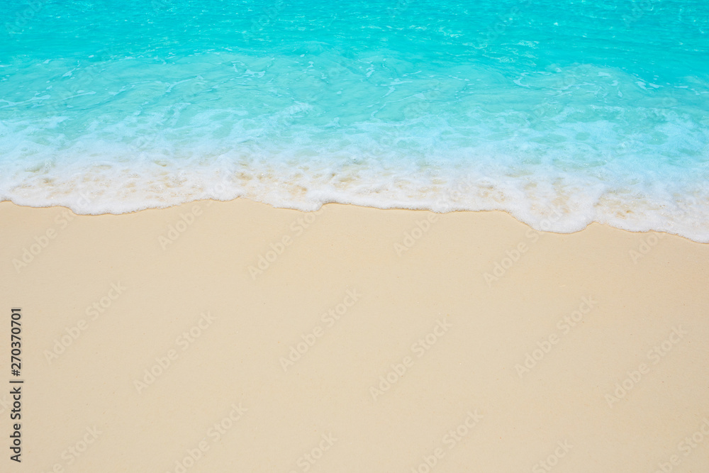 Soft waves of blue sea on the Maldives beach for the background.