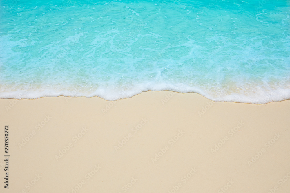 Soft waves of blue sea on the Maldives beach for the background.