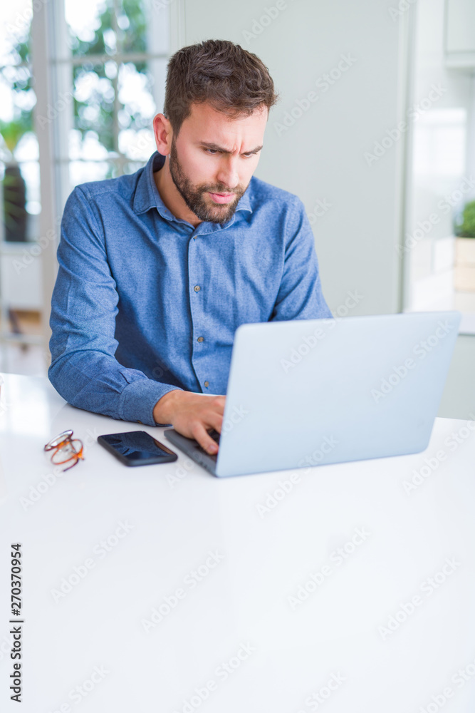 Handsome business man working using computer laptop and smiling Handsome business man working using computer laptop and smiling