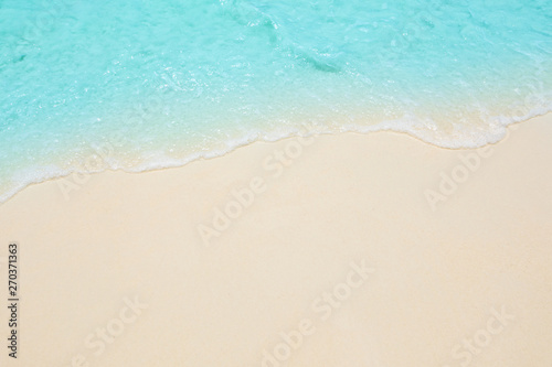 Soft waves of blue sea on the Maldives beach for the background.