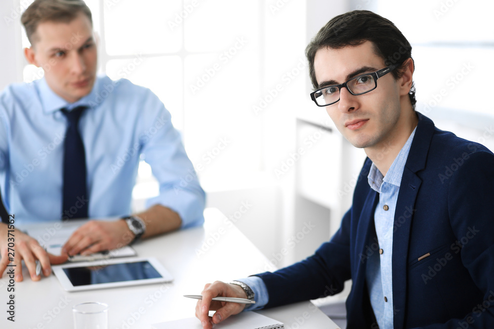 Group of business people discussing questions at meeting in modern office. Managers at negotiation or brainstorm. Teamwork, partnership and business concept Group of business people discussing questions at meeting in modern office. Managers at negotiation or brainstorm. Teamwork, partnership and business concept
