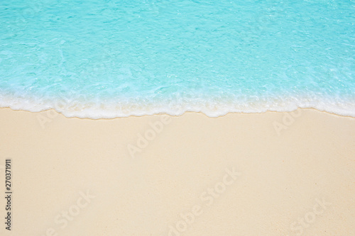 Soft waves of blue sea on the Maldives beach for the background. © chatchawan
