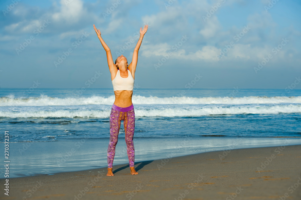 young happy and attractive woman in yoga pants stretching and doing flexibility and meditation exercise at beautiful beach in wellness and healthy natural lifestyle young happy and attractive woman in yoga pants stretching and doing flexibility and meditation exercise at beautiful beach in wellness and healthy natural lifestyle