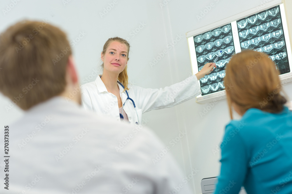 doctors checking a chest xray with couple doctors checking a chest xray with couple