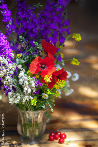 Bouquet of wilfd flowers, poppies, daisies, violets photo