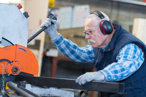 senior man operating machine in the factory