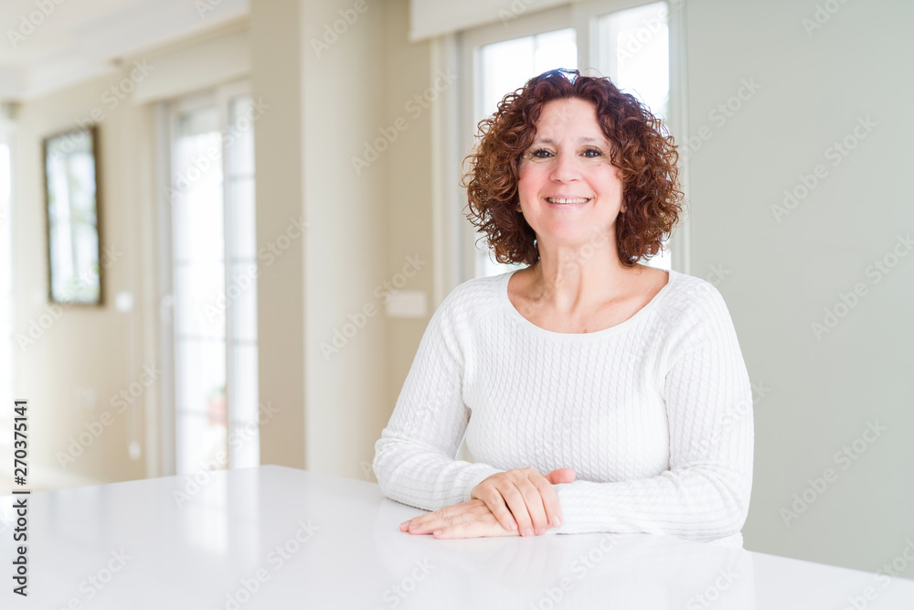 Beautiful senior woman wearing white sweater at home with a happy and cool smile on face. Lucky person. Beautiful senior woman wearing white sweater at home with a happy and cool smile on face. Lucky person.