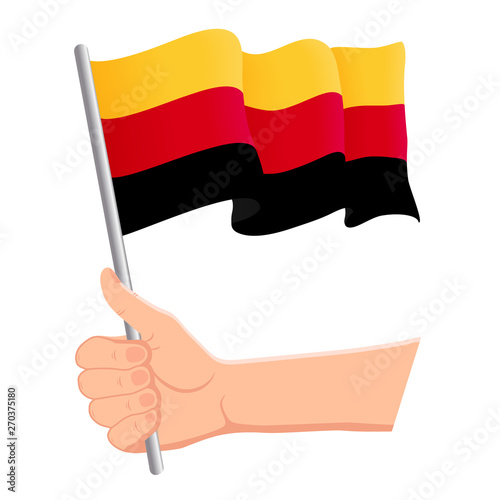 Hand holding and waving the national flag of Germany. Fans  independence day  patriotic concept. Vector illustration  eps 10.