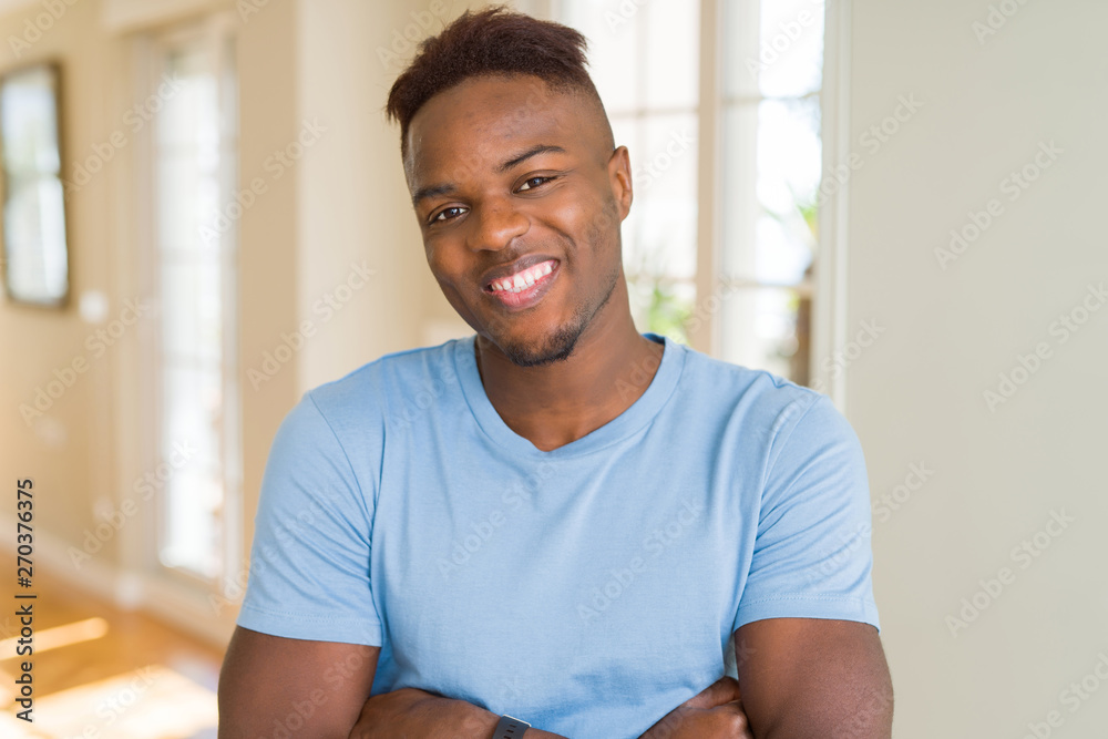 Fototapeta premium Handsome african american man wearing casual t-shirt happy face smiling with crossed arms looking at the camera. Positive person.