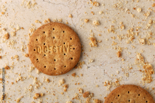 Stack of sweetmeal digestive biscuits closeup of a pile of biscuits on a texture background photo