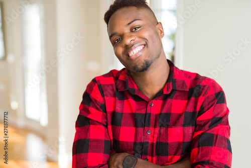 Handsome african american man happy face smiling with crossed arms looking at the camera. Positive person.