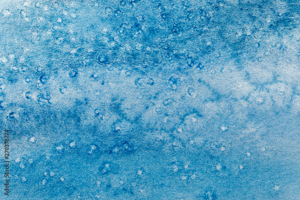 close up view of blue watercolor paint on textured background close up view of blue watercolor paint on textured background