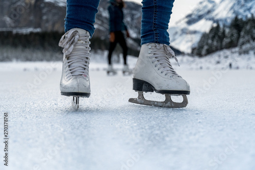 ice skates of a girl on frozen lake