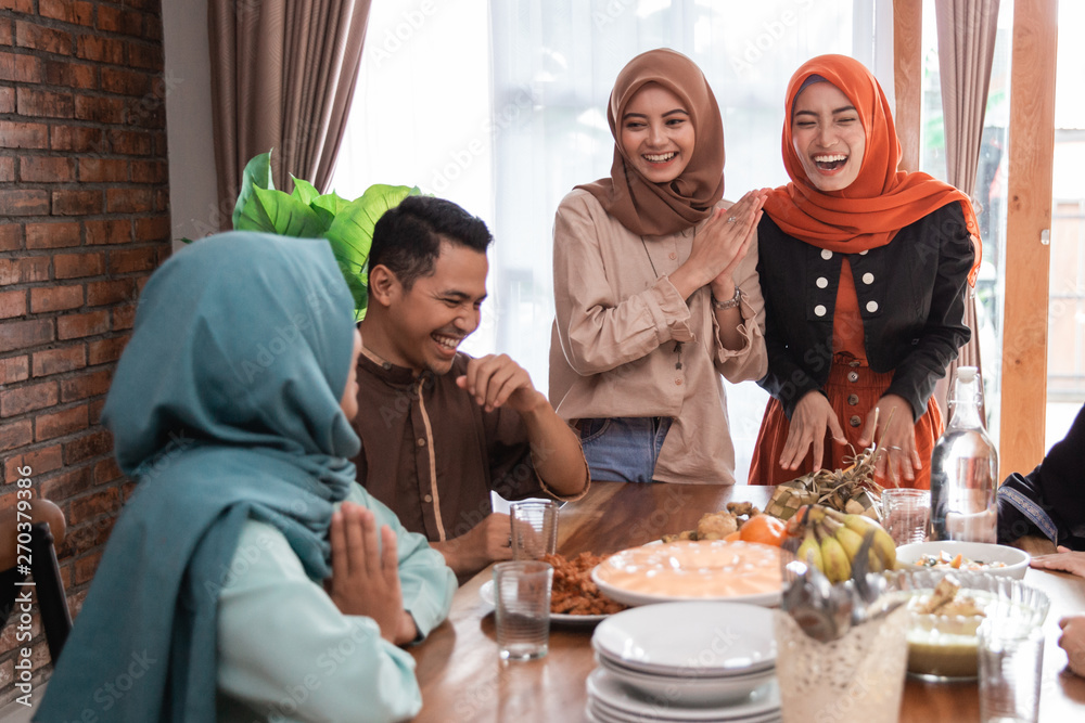 The Hijrah family together enjoy the iftar meal in the dining room The Hijrah family together enjoy the iftar meal in the dining room