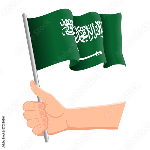 Hand holding and waving the national flag of Saudi Arabia. Fans, independence day, patriotic concept. Vector illustration, eps 10.