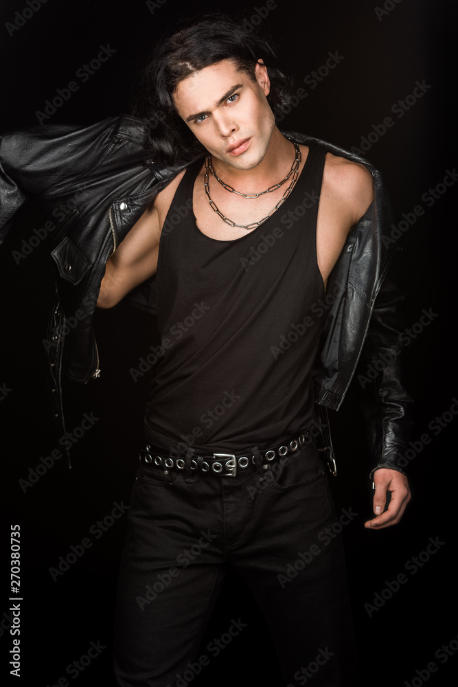 handsome man wearing leather jacket and looking at camera isolated on black handsome man wearing leather jacket and looking at camera isolated on black