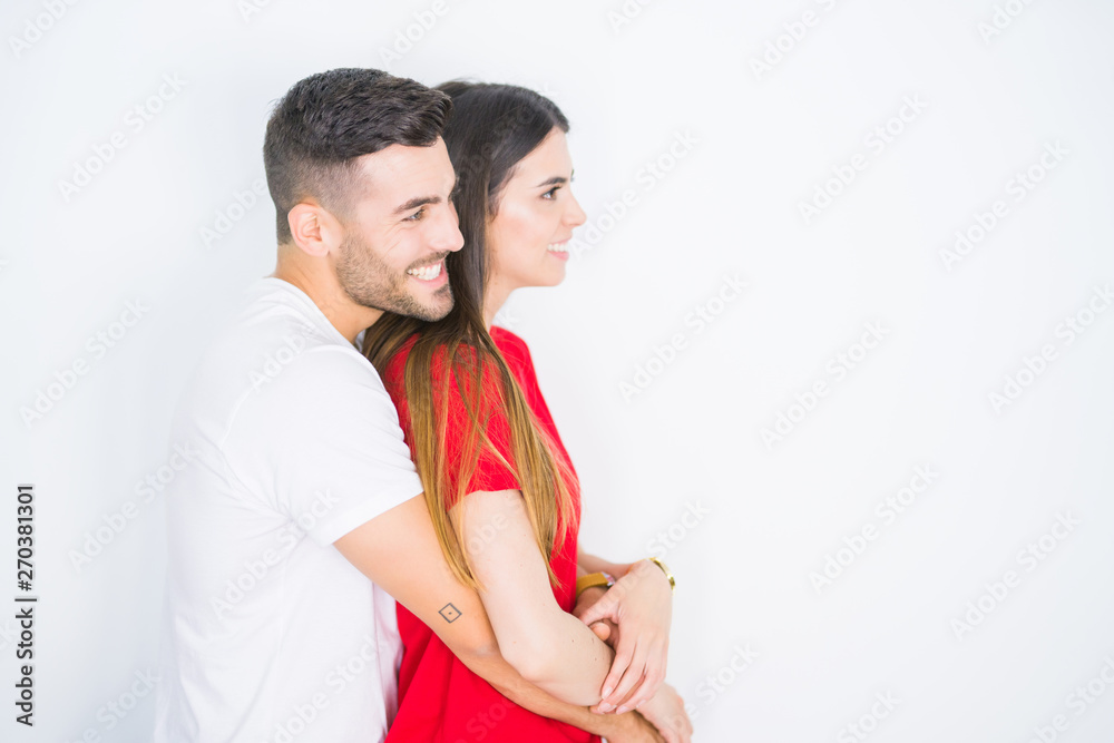 Young beautiful couple together over white isolated background looking to side, relax profile pose with natural face with confident smile. Young beautiful couple together over white isolated background looking to side, relax profile pose with natural face with confident smile.