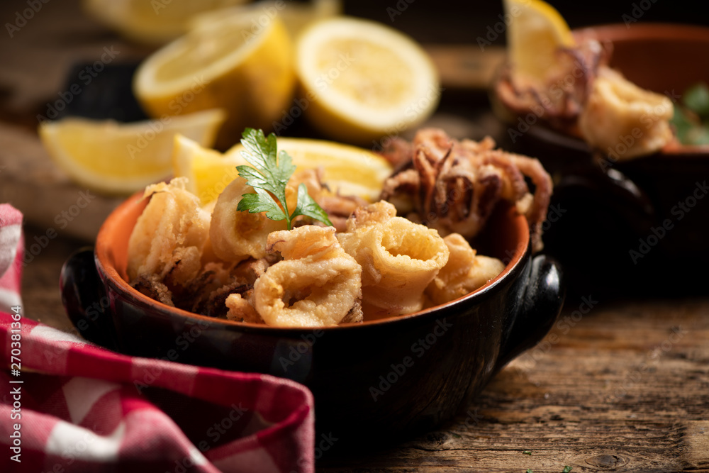 Traditional Italian fried calamari and lemon slice Traditional Italian fried calamari and lemon slice