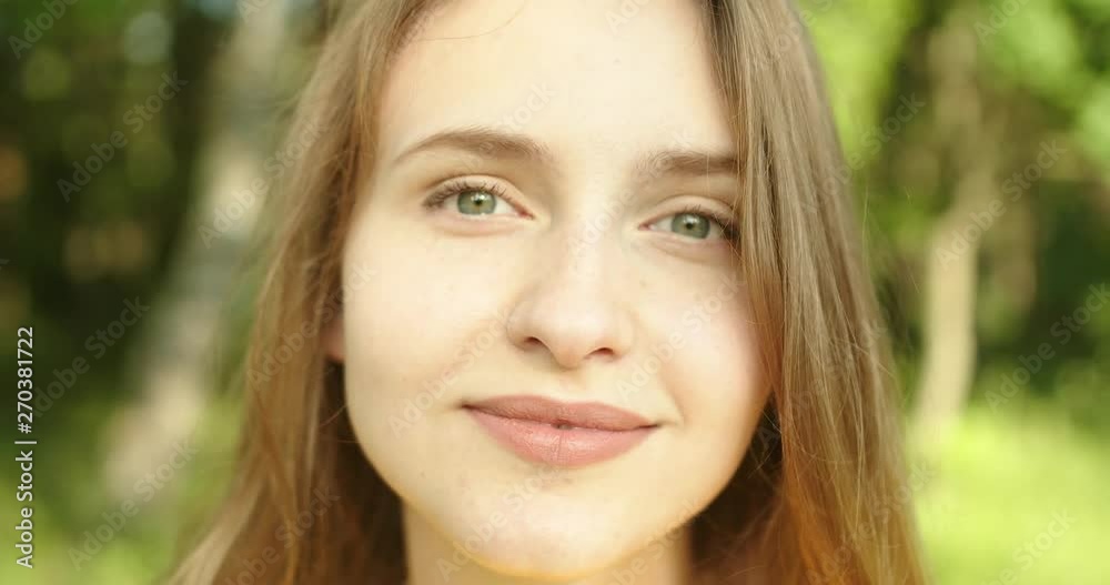 Beautiful girl front the camera with smile at nature close up Beautiful girl front the camera with smile at nature close up