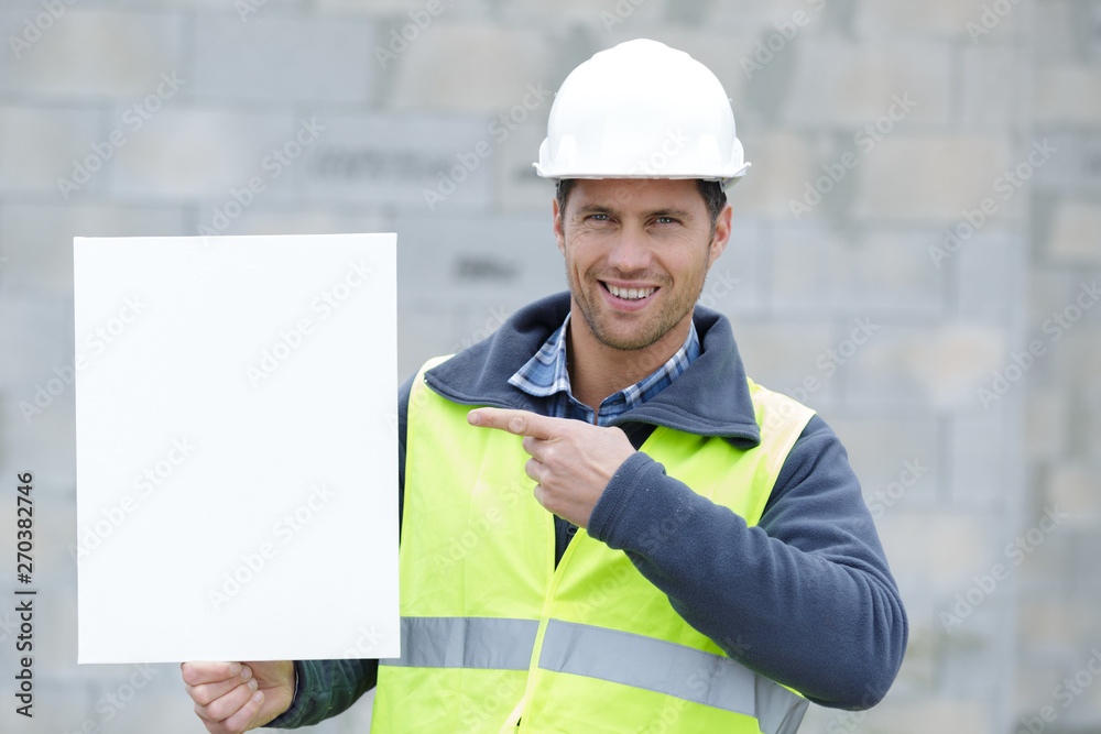 engineer is standing holding a board engineer is standing holding a board