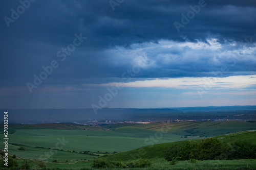 Heavy rain over the meadows at evening.